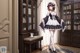 A woman in a maid outfit standing in front of a bookcase.