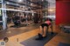 A woman doing push ups in a gym. 