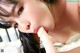 A woman with long black hair is sucking a white dildo.