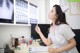 A woman sitting at a desk in front of a computer.