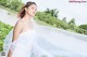 A woman in a white wedding dress with a long veil.